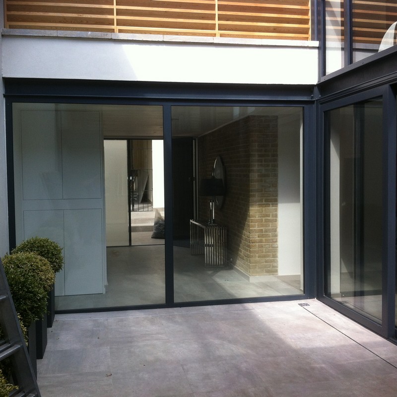 Floor-to-ceiling sliding doors opening to courtyard in Stanmore