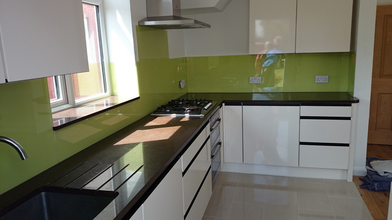 Lime green glass kitchen splashback installed by Stanmore glaziers