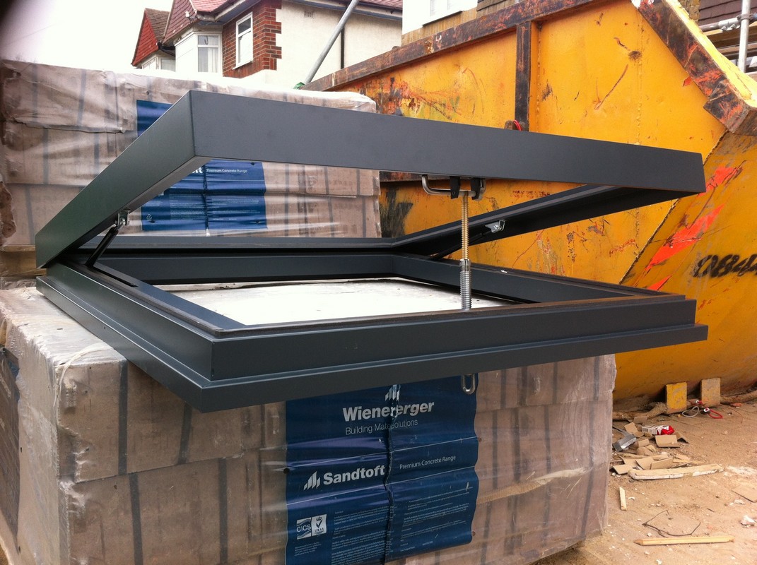 Opening flat roof skylight in anthracite grey installed in Stanmore